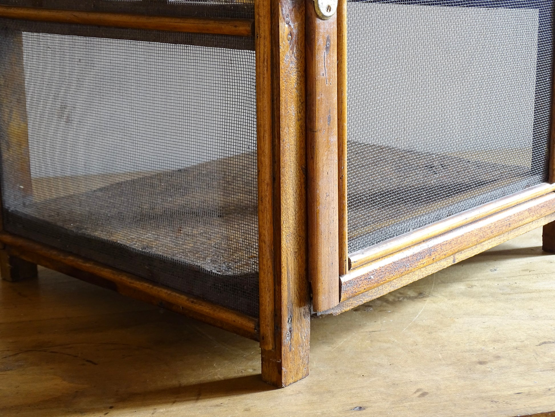 A French antique garde manger or countertop pantry cabinet. Circa 1920. This antique wooden garde manger with wire mesh panels on all sides was traditionally used for storing cheese, fruit, and baked goods while allowing air to circulate.