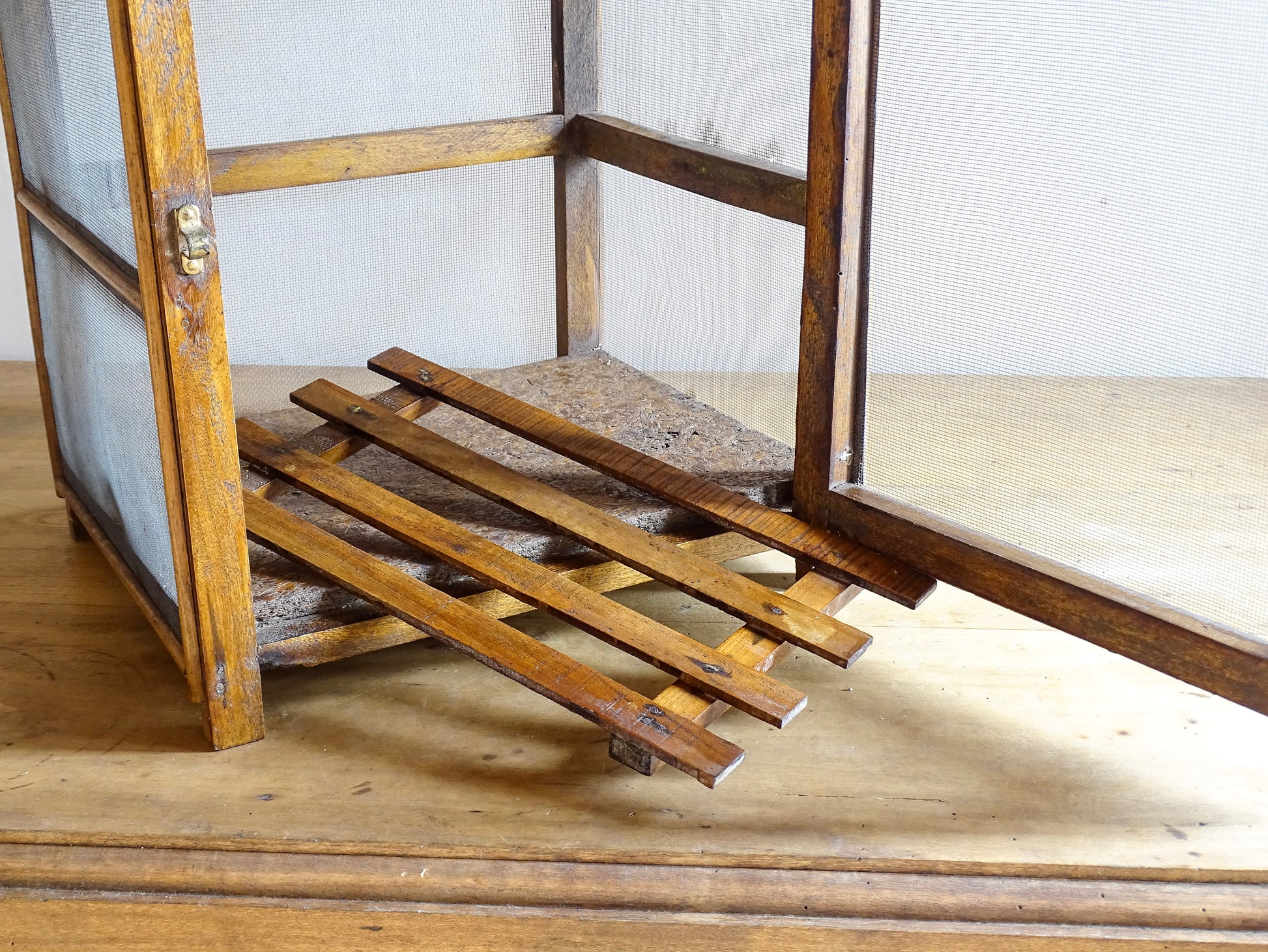 A French antique garde manger or countertop pantry cabinet. Circa 1920. This antique wooden garde manger with wire mesh panels on all sides was traditionally used for storing cheese, fruit, and baked goods while allowing air to circulate.