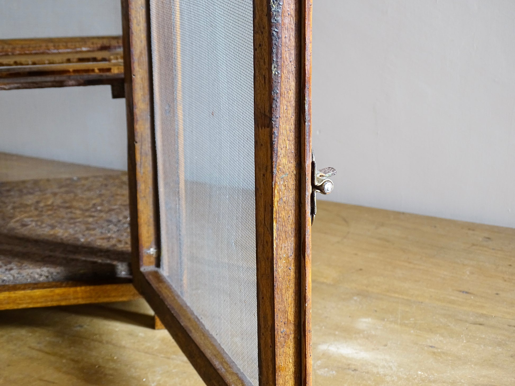 A French antique garde manger or countertop pantry cabinet. Circa 1920. This antique wooden garde manger with wire mesh panels on all sides was traditionally used for storing cheese, fruit, and baked goods while allowing air to circulate.