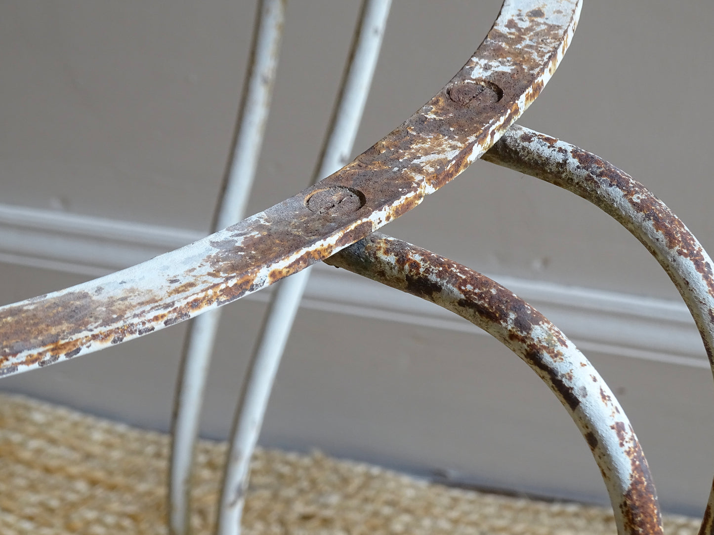 French antique wrought iron patio table base, early 20th century, round support ring with scrolled legs. Designed for a marble or stone top, suitable for a terrace or garden setting.