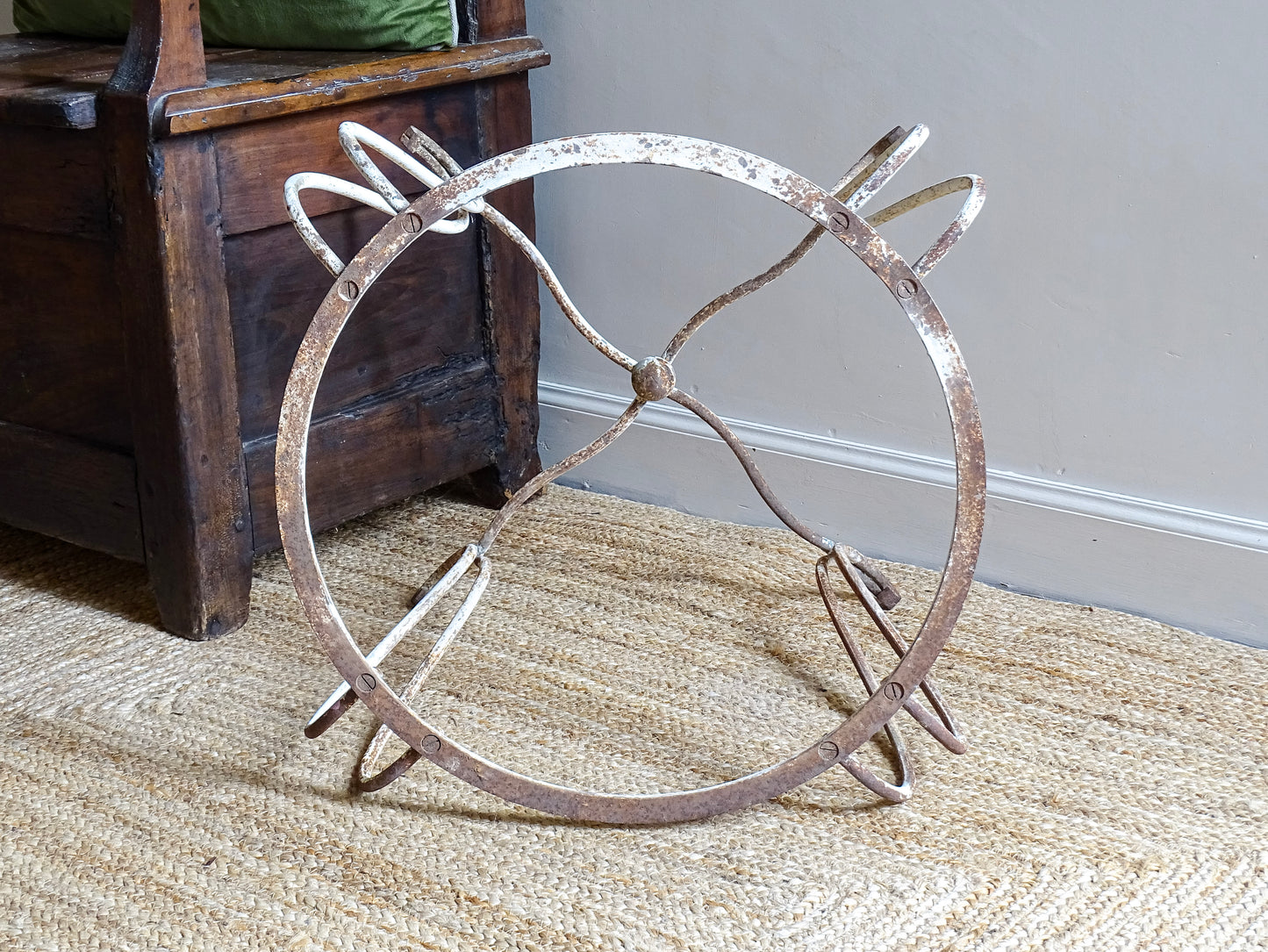 French antique wrought iron patio table base, early 20th century, round support ring with scrolled legs. Designed for a marble or stone top, suitable for a terrace or garden setting.