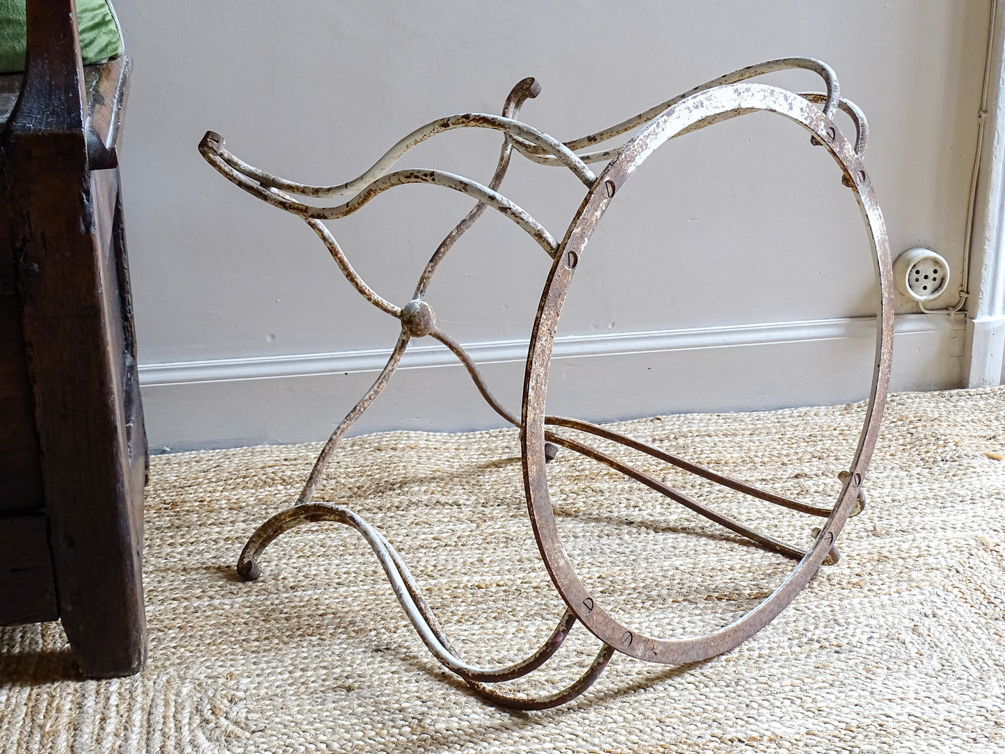 French antique wrought iron patio table base, early 20th century, round support ring with scrolled legs. Designed for a marble or stone top, suitable for a terrace or garden setting.