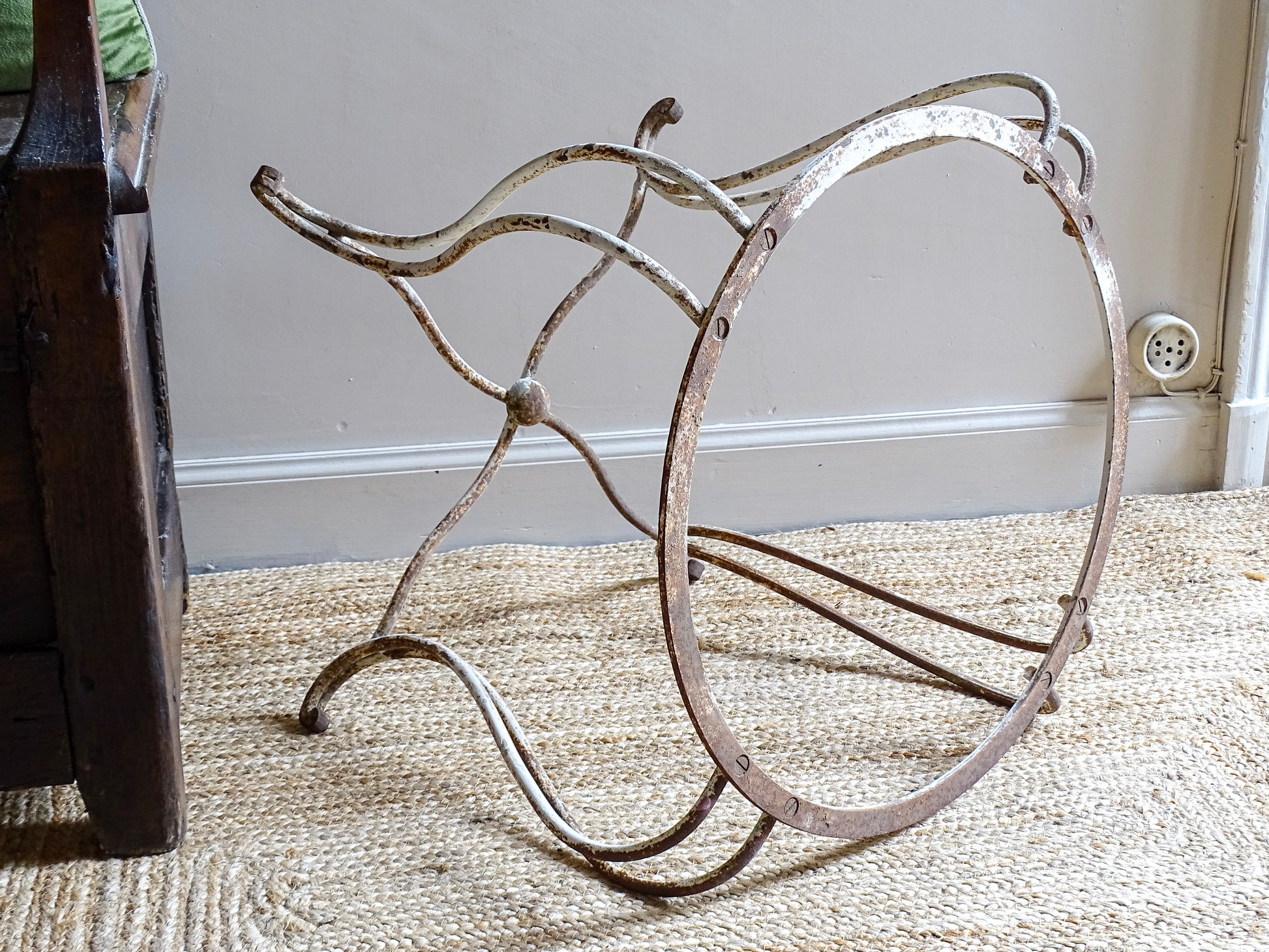 French antique wrought iron patio table base, early 20th century, round support ring with scrolled legs. Designed for a marble or stone top, suitable for a terrace or garden setting.