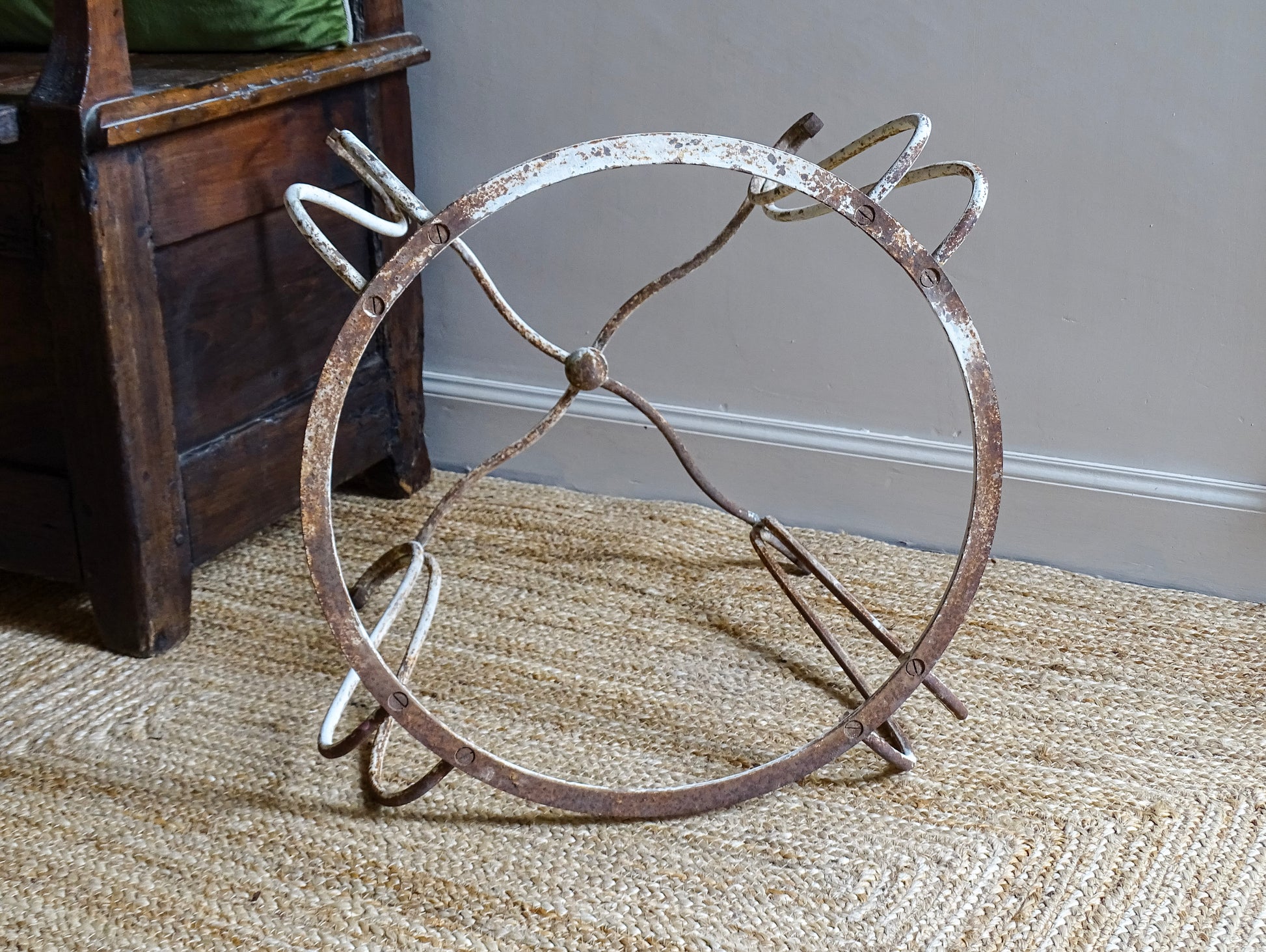 French antique wrought iron patio table base, early 20th century, round support ring with scrolled legs. Designed for a marble or stone top, suitable for a terrace or garden setting.