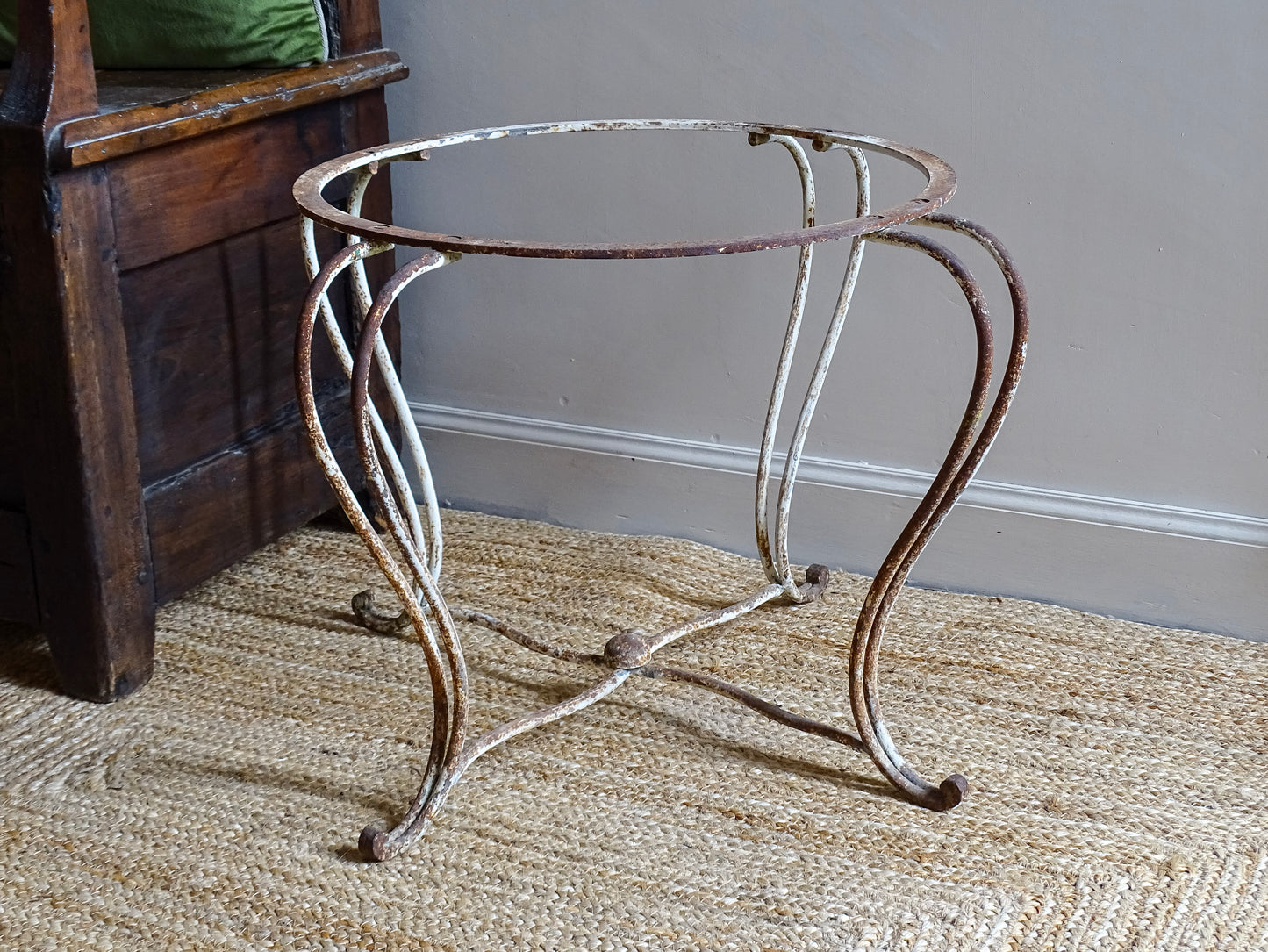 French antique wrought iron patio table base, early 20th century, round support ring with scrolled legs. Designed for a marble or stone top, suitable for a terrace or garden setting.