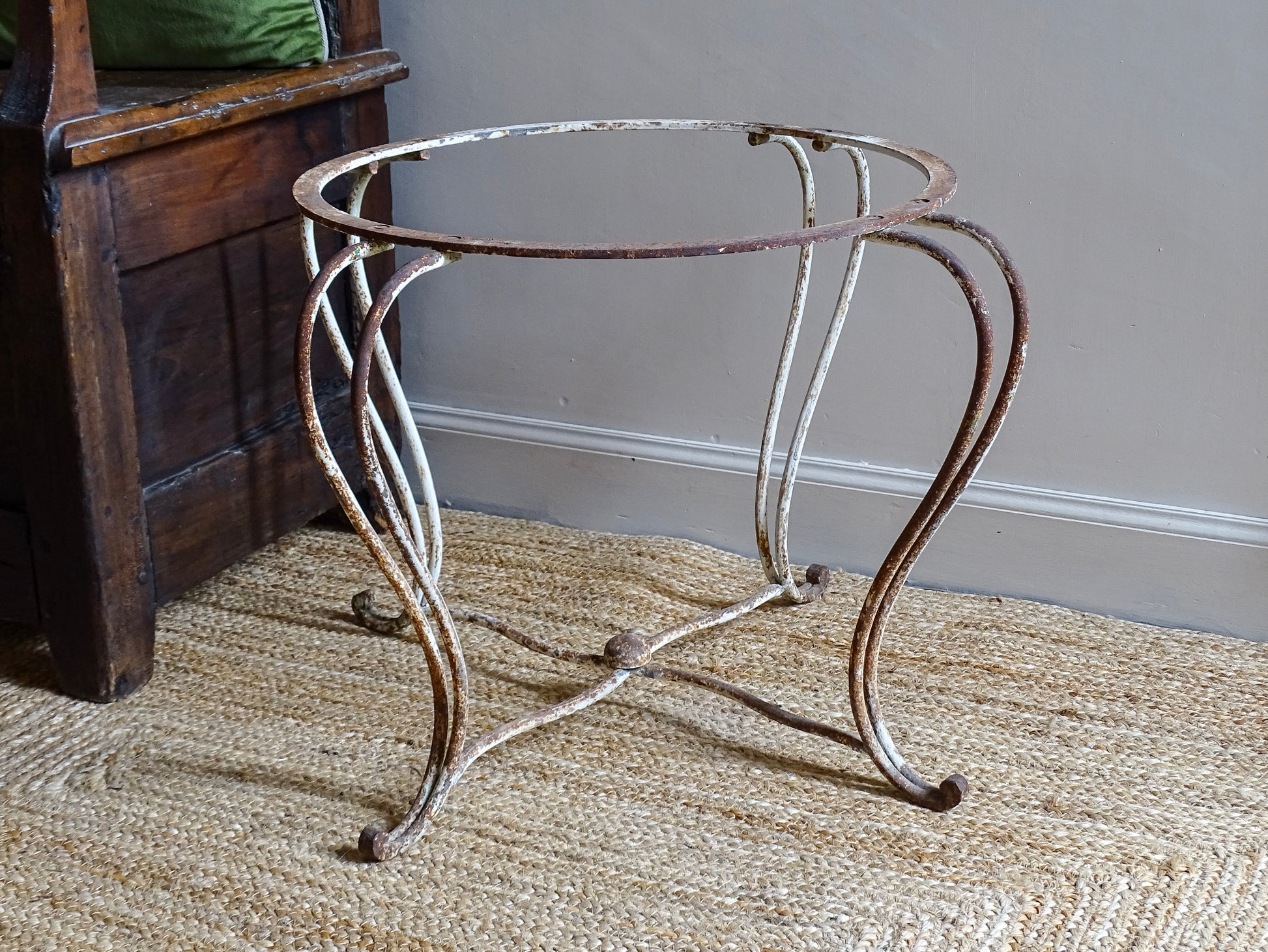 French antique wrought iron patio table base, early 20th century, round support ring with scrolled legs. Designed for a marble or stone top, suitable for a terrace or garden setting.