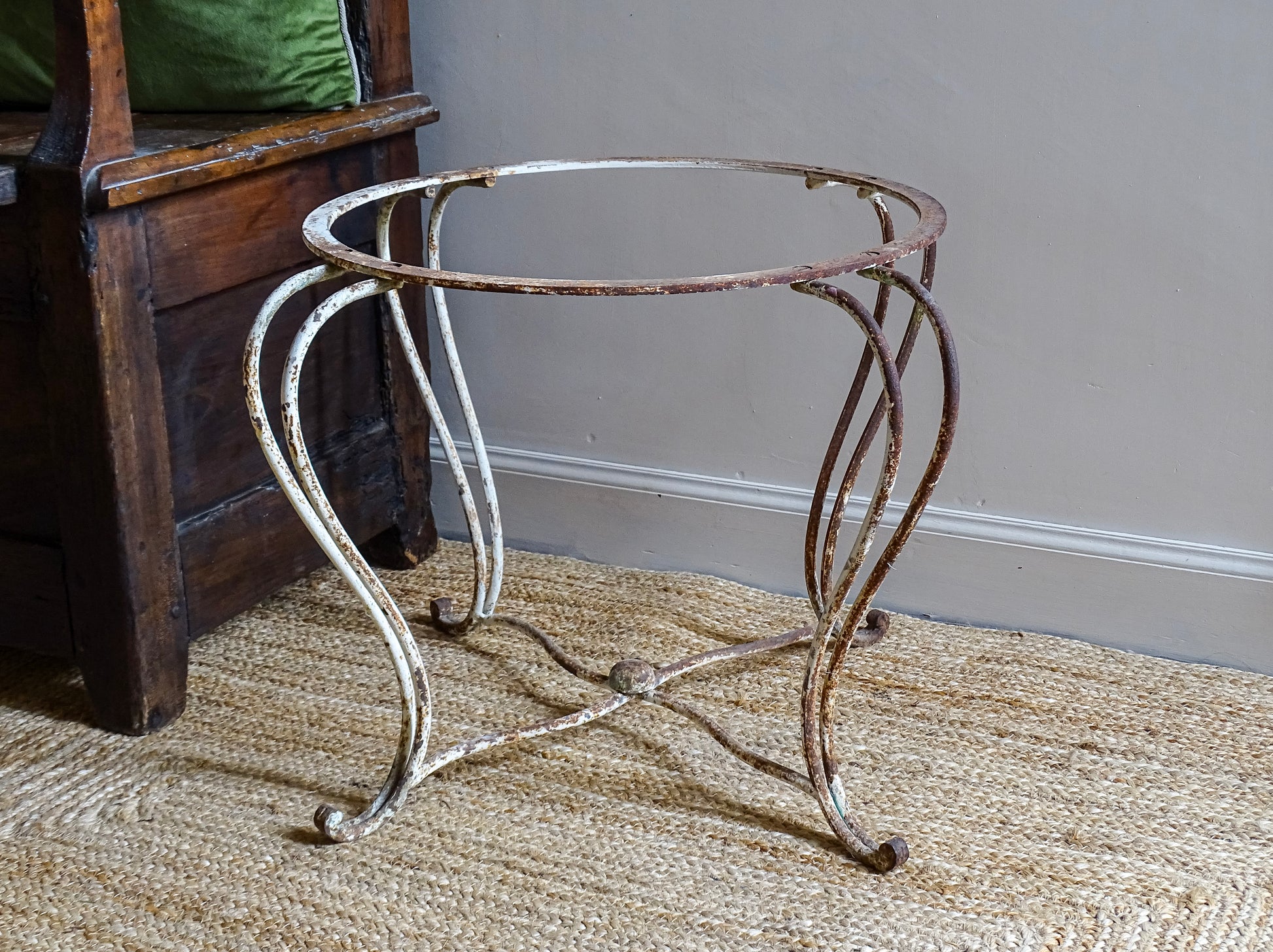 French antique wrought iron patio table base, early 20th century, round support ring with scrolled legs. Designed for a marble or stone top, suitable for a terrace or garden setting.