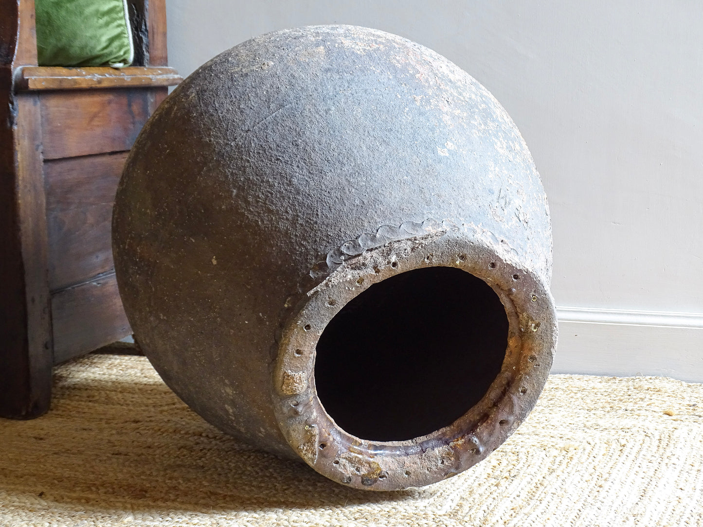 A large, early 19th century French antique terracotta pot, known as a ponne (salting pot), sourced in the Bordeaux region and likely Charentais in origin. This example has a beautifully rounded, generous form with a rolled rim. The surface is particularly special, showing layers of time, wear and historic pigment. Traces of faded blue and earthy tones remain across the body, creating a richly textured patina. 