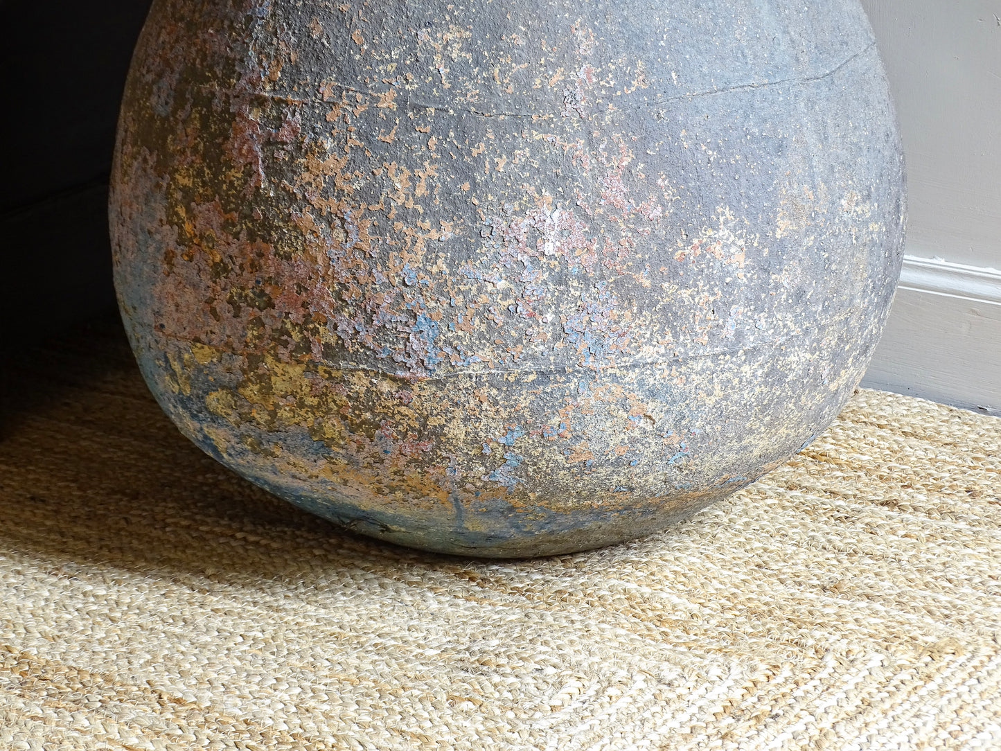 A large, early 19th century French antique terracotta pot, known as a ponne (salting pot), sourced in the Bordeaux region and likely Charentais in origin. This example has a beautifully rounded, generous form with a rolled rim. The surface is particularly special, showing layers of time, wear and historic pigment. Traces of faded blue and earthy tones remain across the body, creating a richly textured patina. 