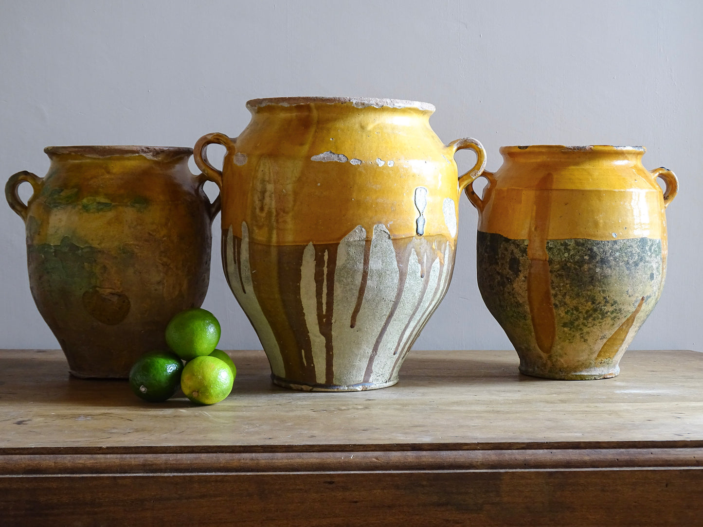 Large French antique confit pot with an ochre yellow glaze. These beautiful pots were originally used to preserve meats in the South of France. This confit jar would look beautiful placed on console table or kitchen counter, fill it with dried flowers or display with a collection of French pottery.