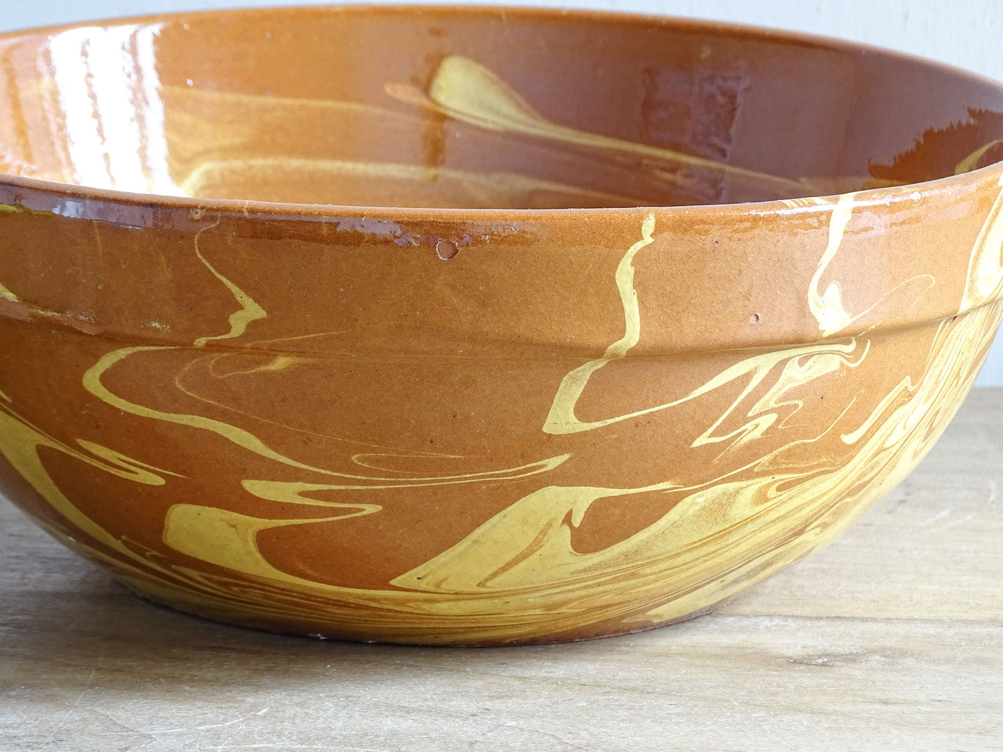 Antique French earthenware mixing bowl with yellow and brown jaspe slip glaze
