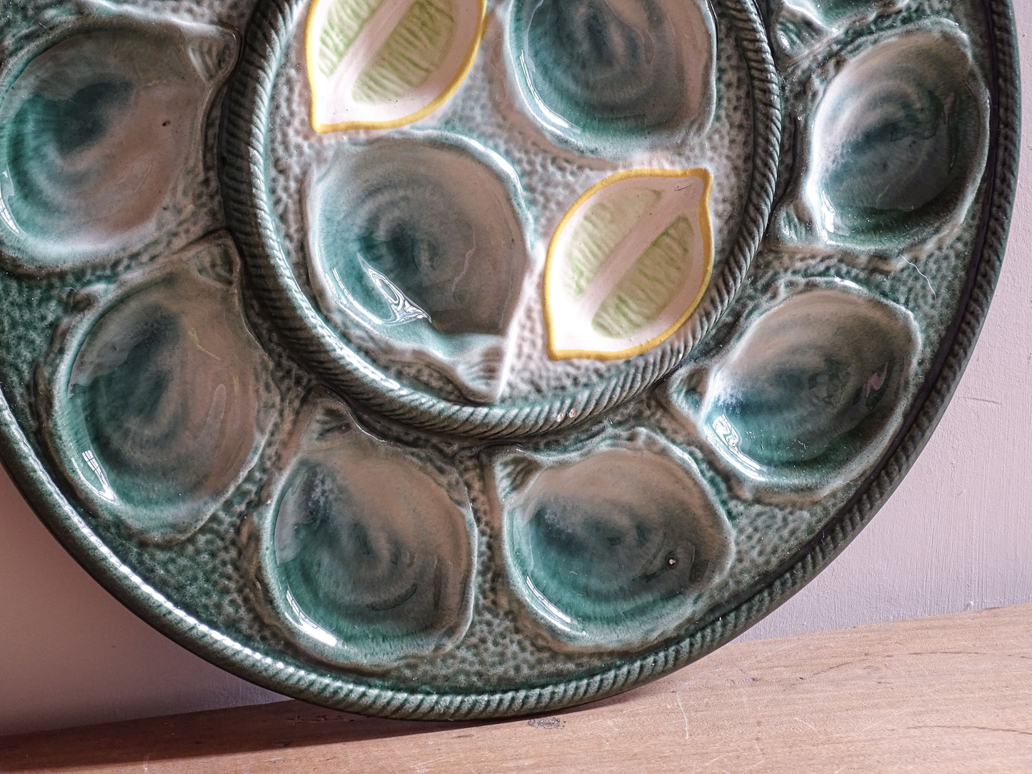 Detail of textured green glaze on a French ceramic oyster plate by St Clément.