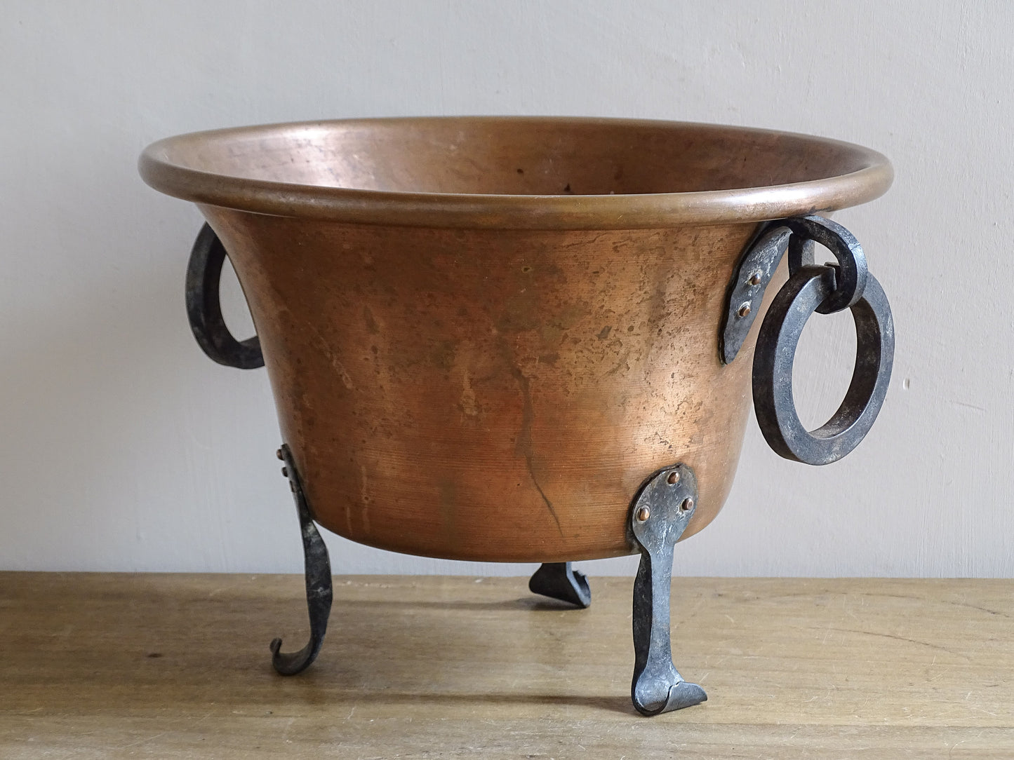 French vintage copper jardinière showing warm patinated copper and hand-forged iron details.