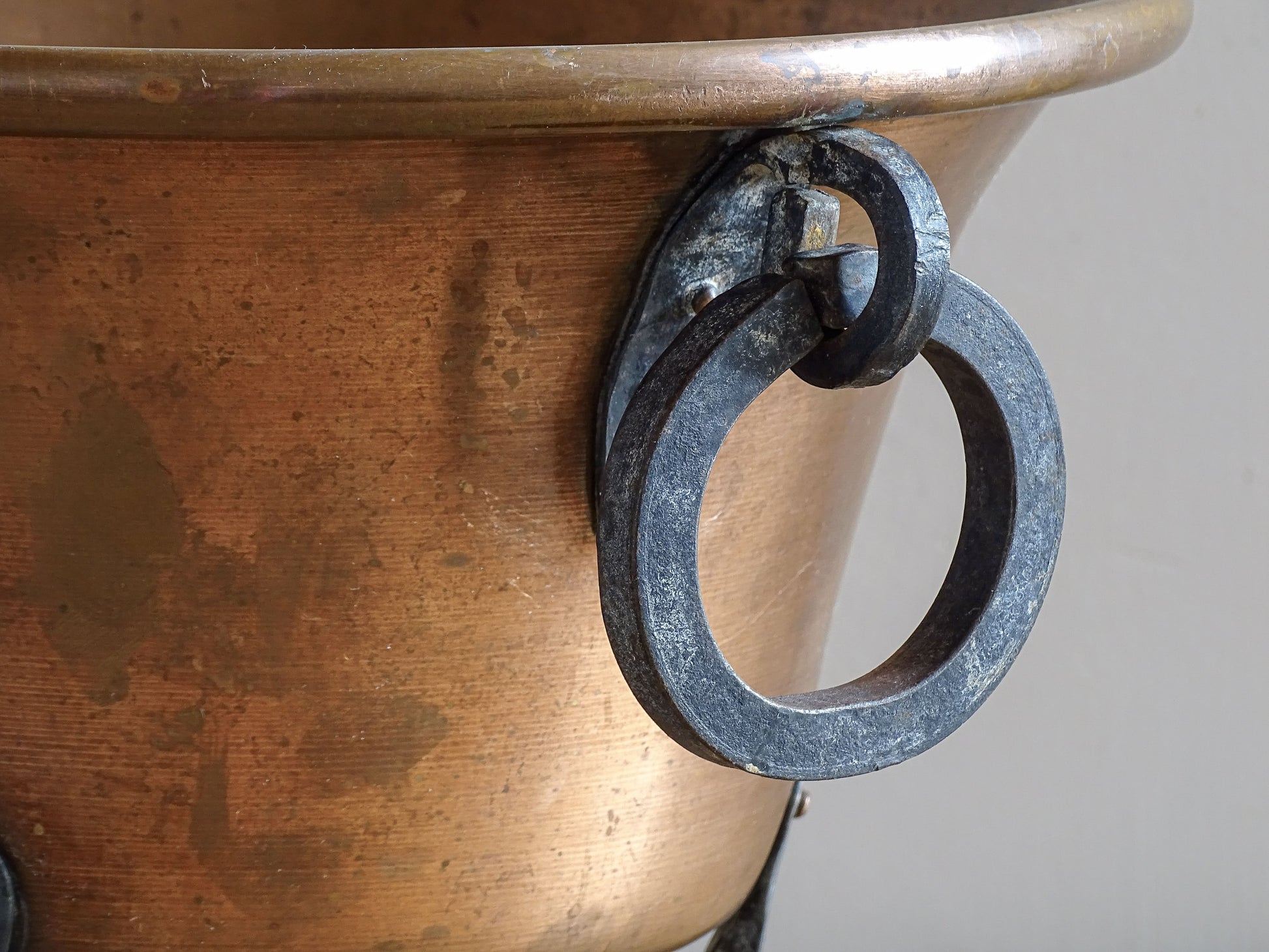 Detail of wrought iron ring handle on a vintage French copper planter.