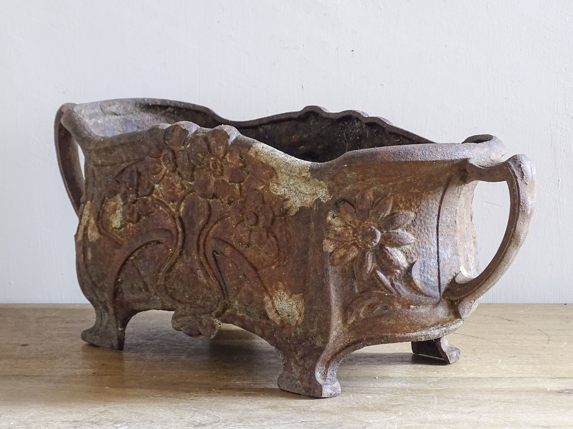 Antique Art Nouveau jardinière with flowing lines and floral design in cast iron.