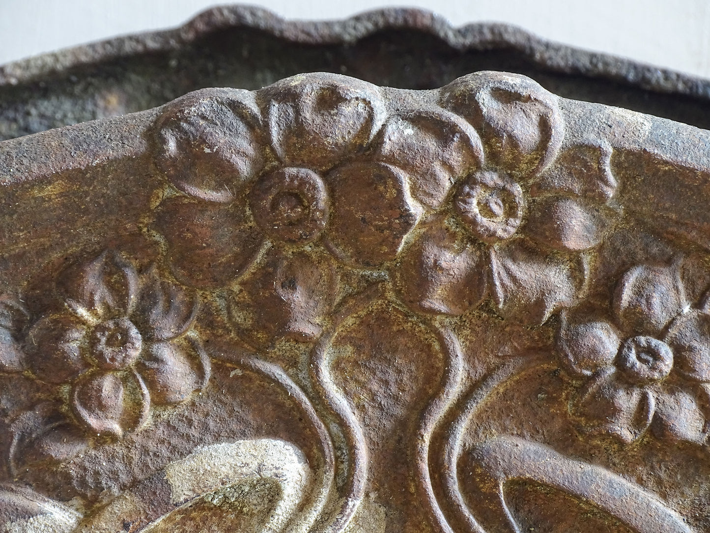 Decorative French cast iron planter with handles and raised feet.