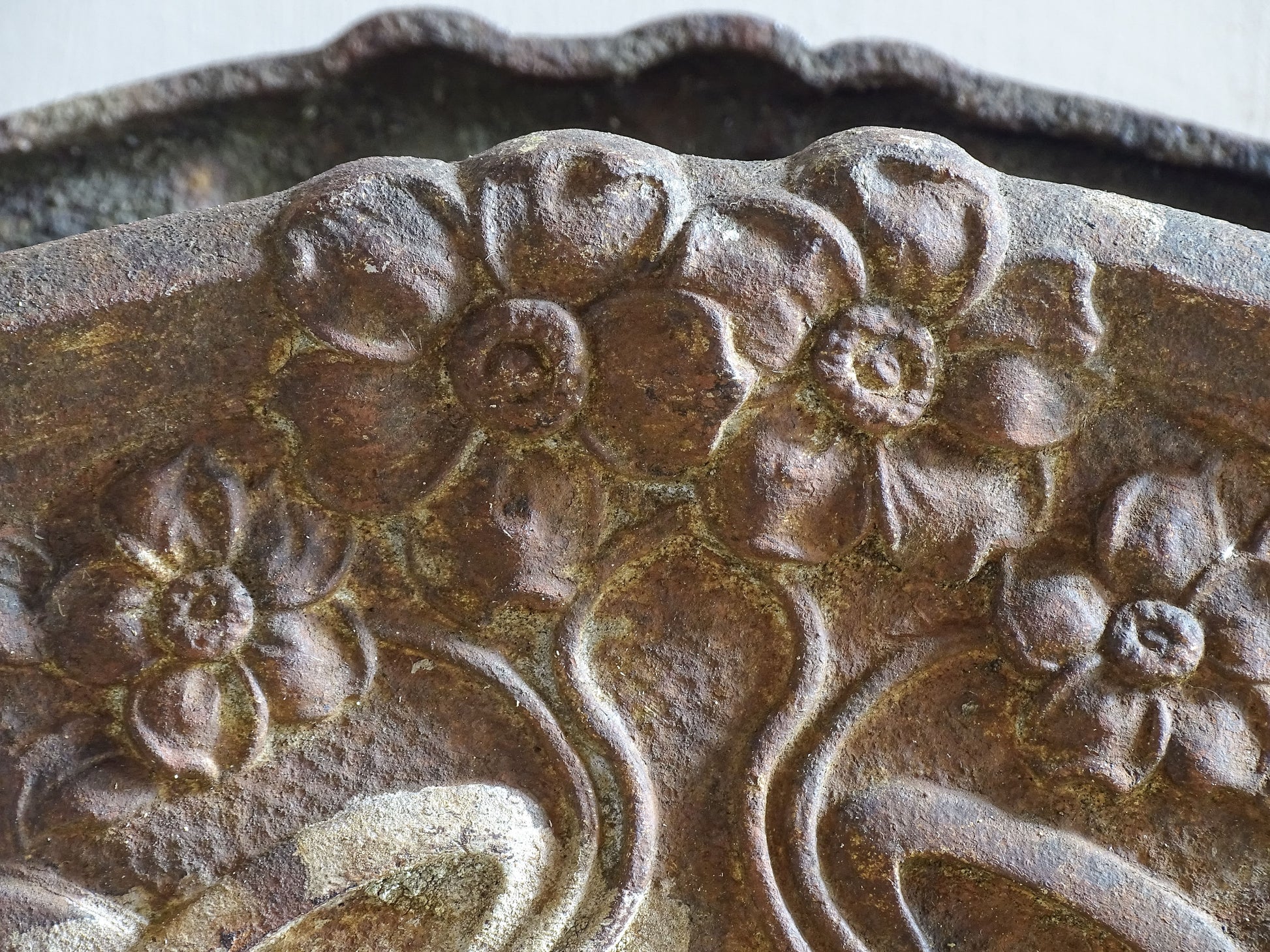 Decorative French cast iron planter with handles and raised feet.