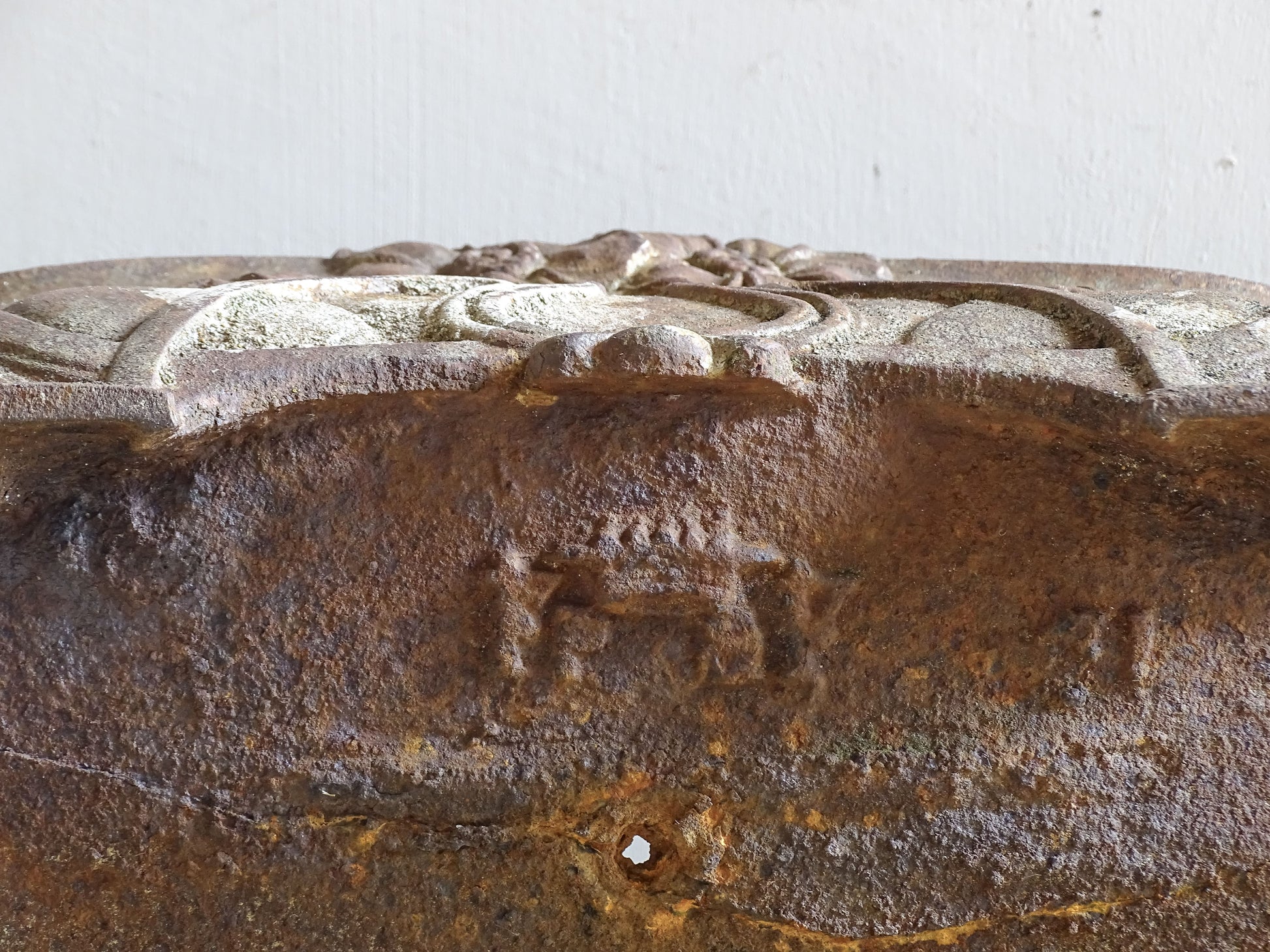 Detail of floral relief design on an Art Nouveau cast iron planter from France.