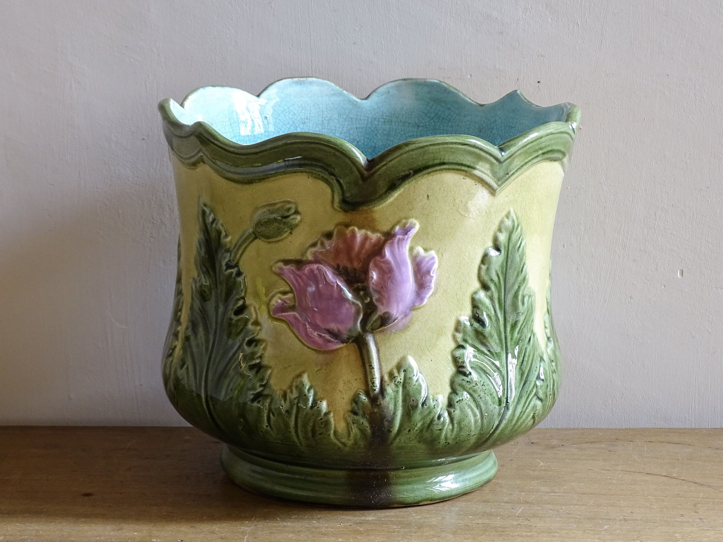 Antique relief decorated ceramic flower pot with poppy motif