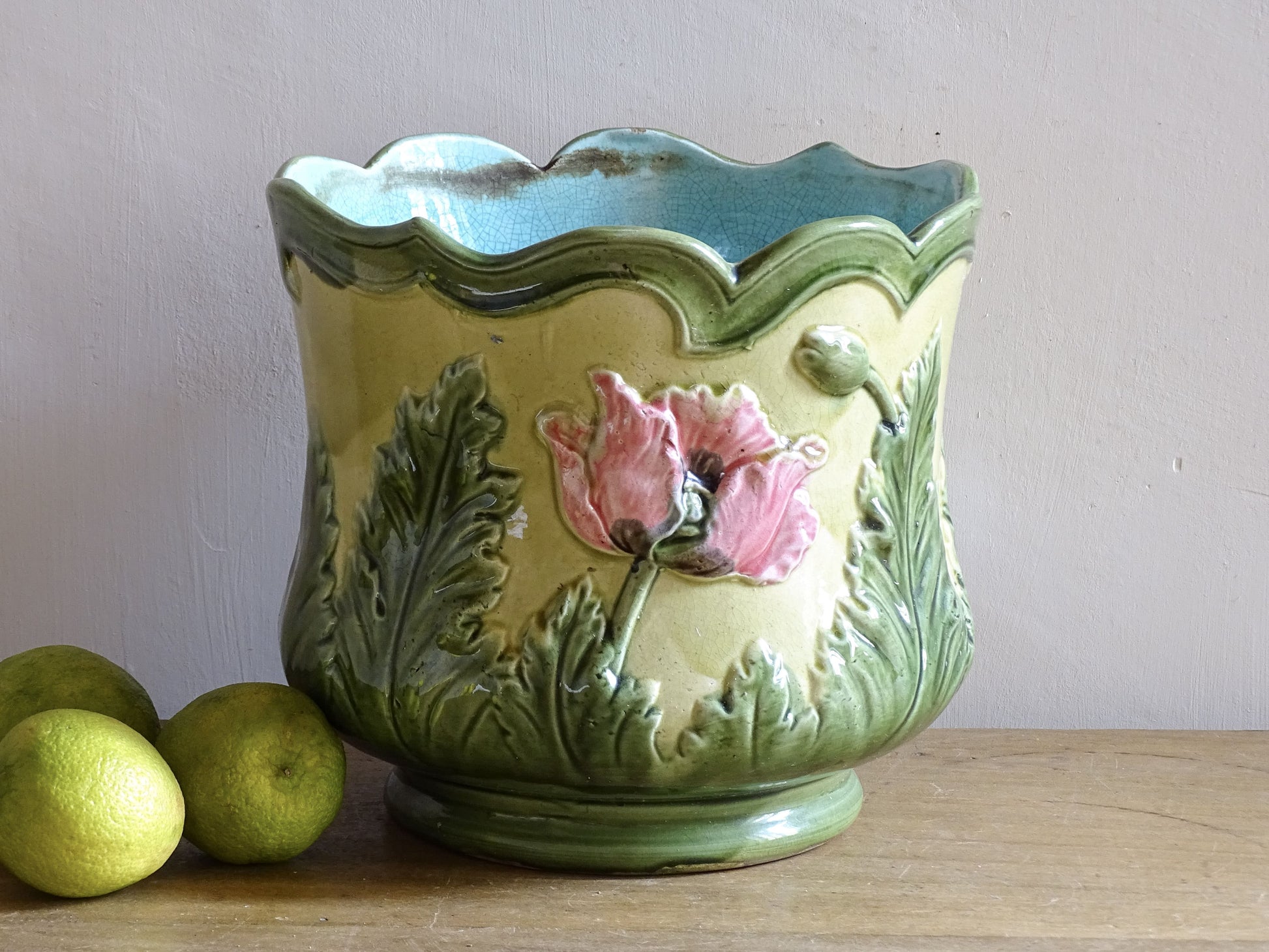 Antique ceramic cache pot with poppy relief decoration and scalloped rim