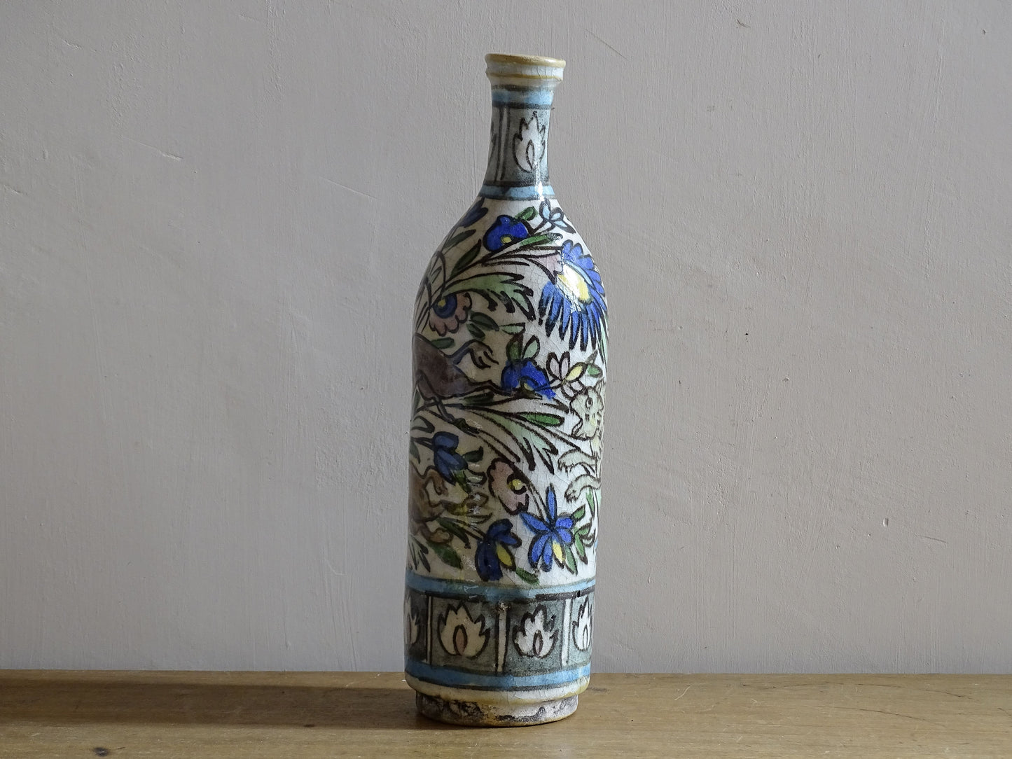 Tall hand painted ceramic bottle in the Iznik revival style.