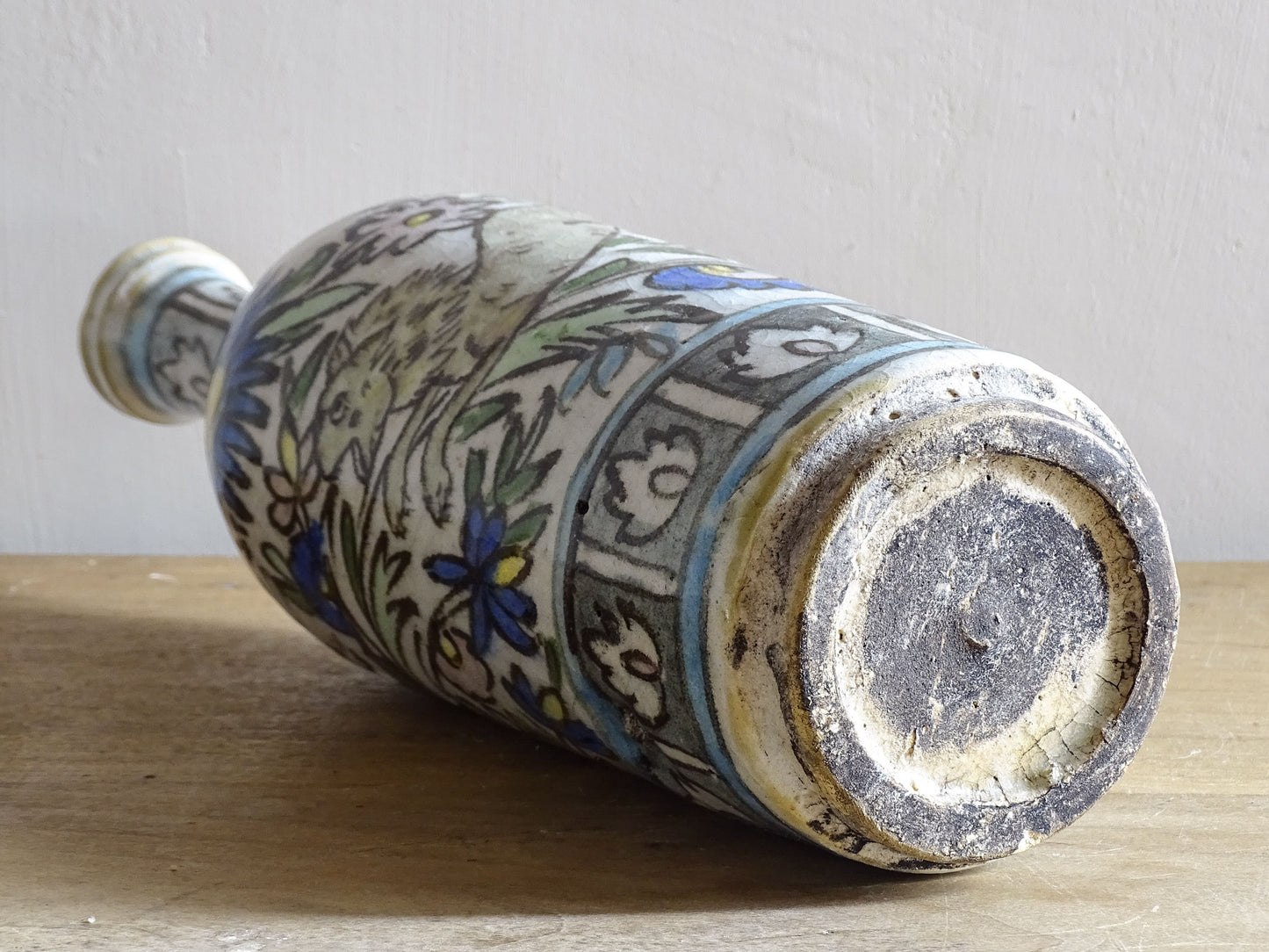 Tall antique Iznik style pottery vase with animal decoration.