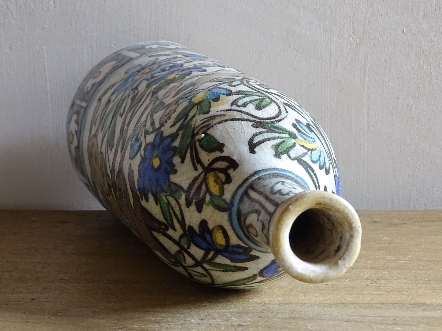 Tall antique Iznik style pottery vase with animal decoration.