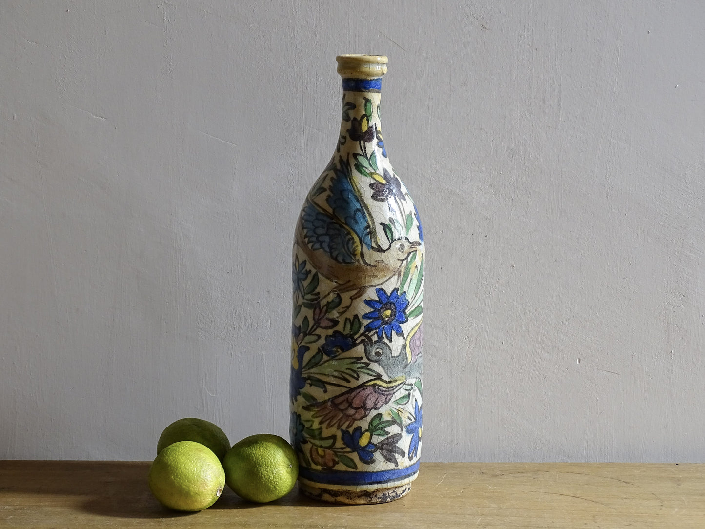 Antique Iznik style pottery bottle with birds and floral decoration.