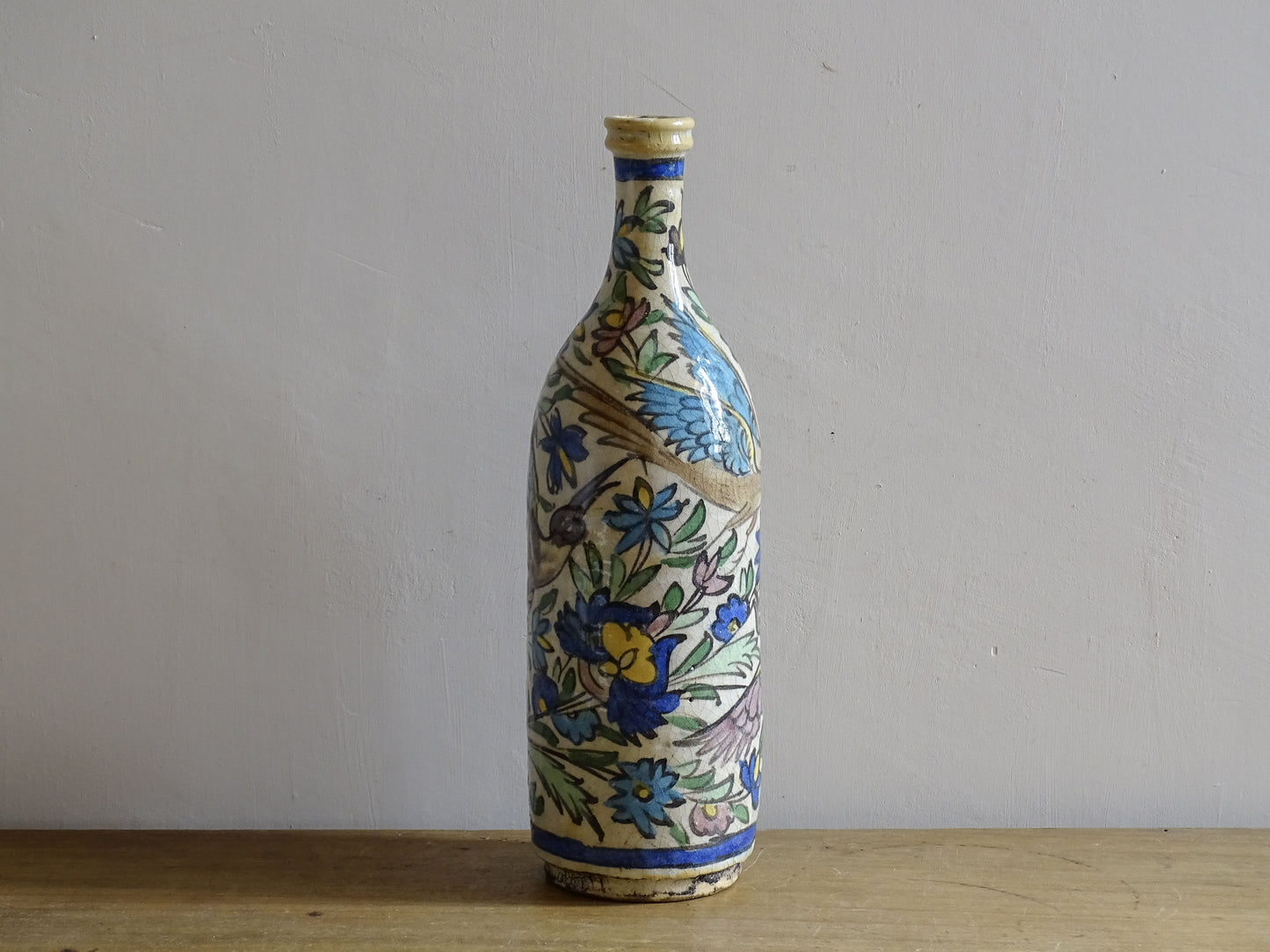 Ottoman style pottery bottle with hand painted birds and foliage.