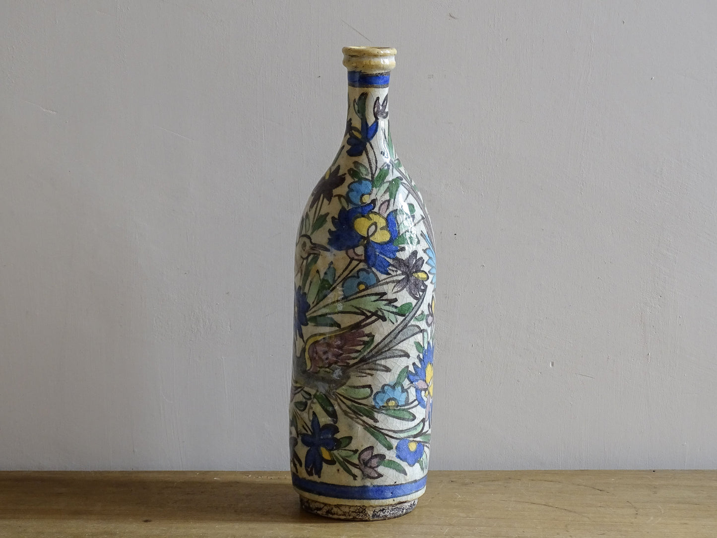 Antique ceramic bottle with colourful Iznik inspired bird design.