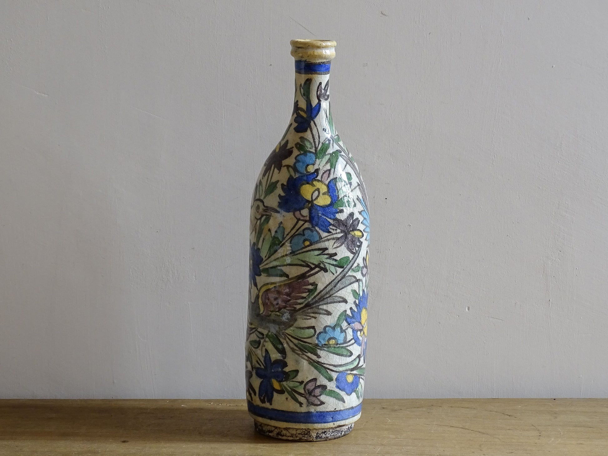 Antique ceramic bottle with colourful Iznik inspired bird design.