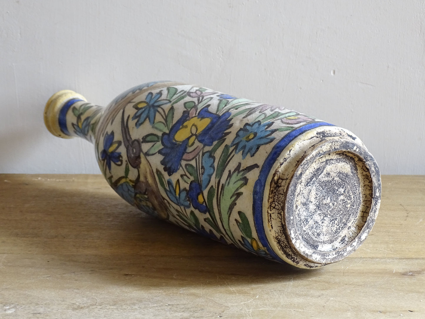 Antique Iznik style earthenware bottle with bird and floral design.