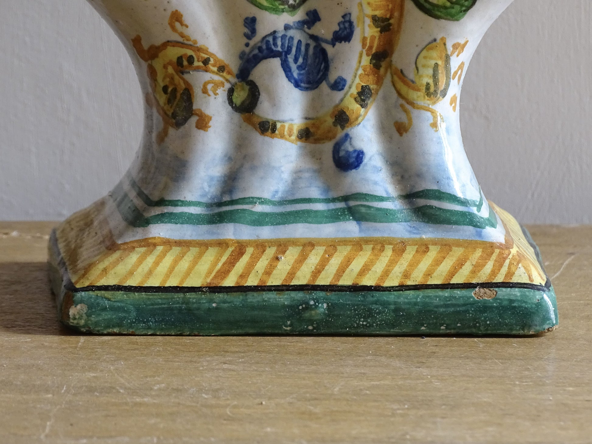 Antique Italian faience tulip vase with mythical creature decoration.