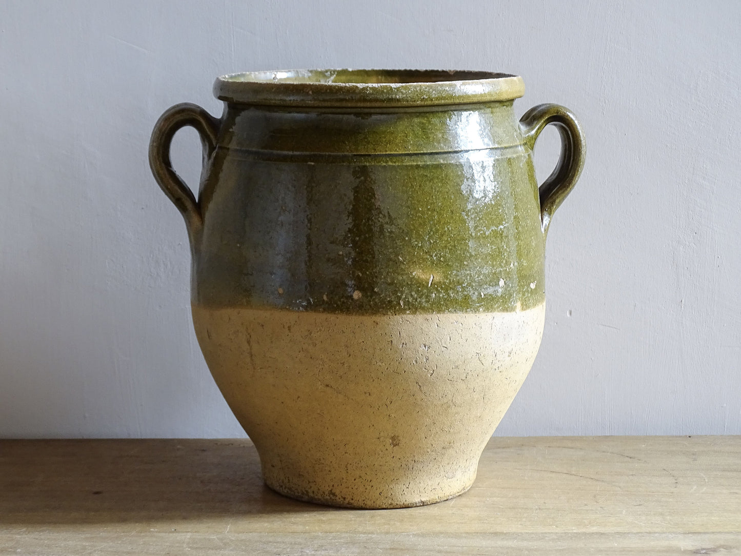 French antique confit pot with green glazed upper half and twin handles