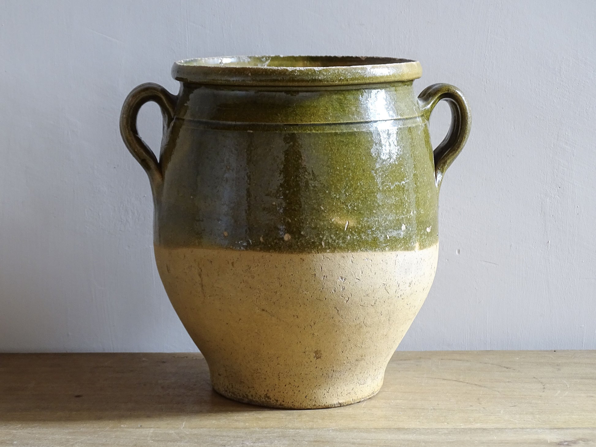 French antique confit pot with green glazed upper half and twin handles