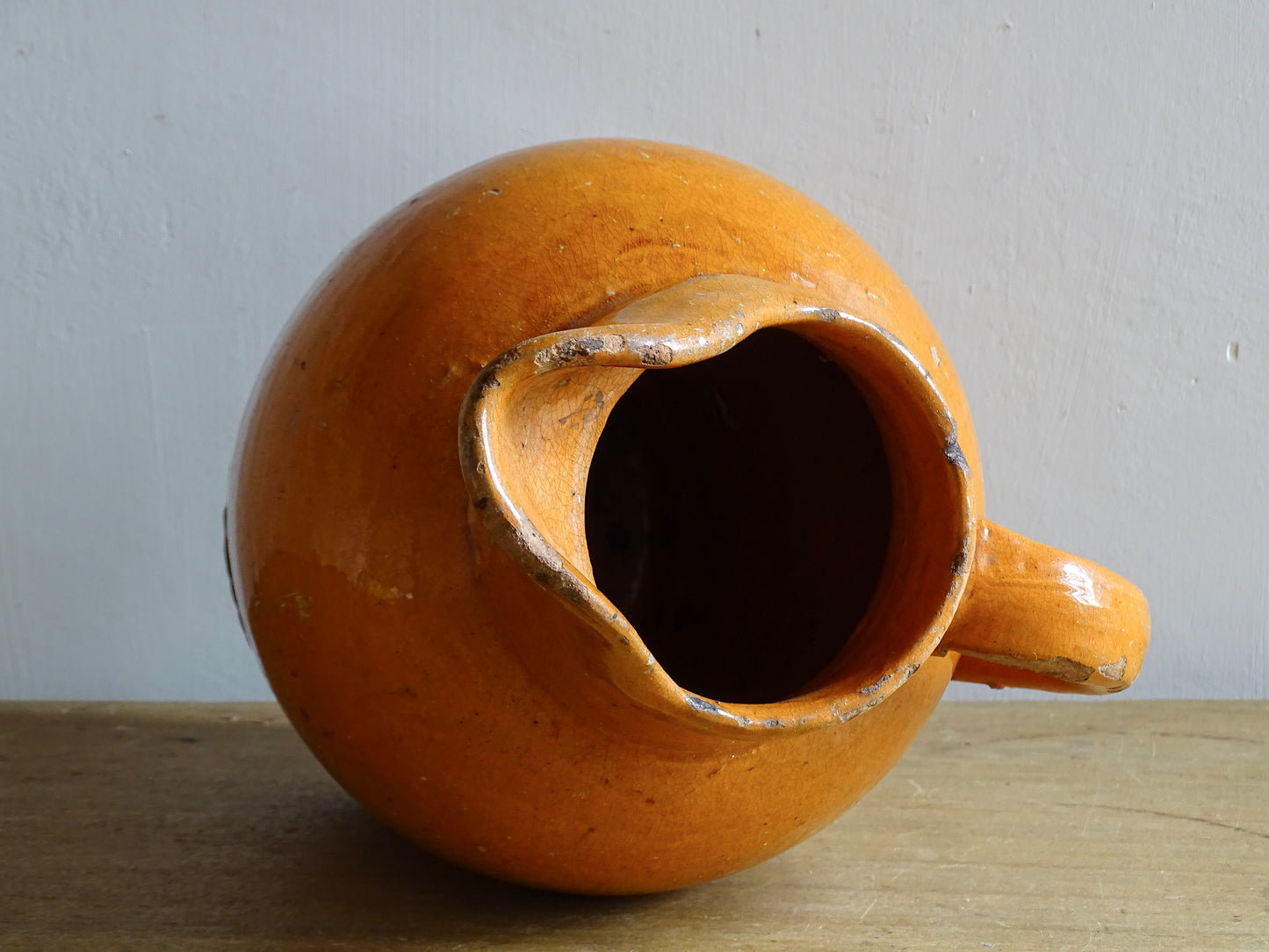 Antique terracotta pitcher from Provence or Languedoc with orange glaze