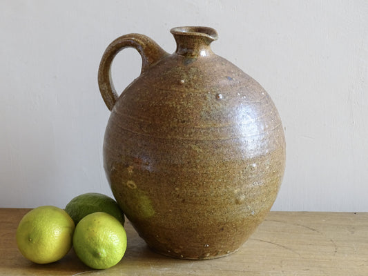 A rustic French antique pottery water or wine pitcher. It has gorgeous warm brown tones. This ceramic jug dates  from the nineteenth century