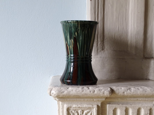 French antique ceramic vase with a blue glaze, pictured on a country house fireplace