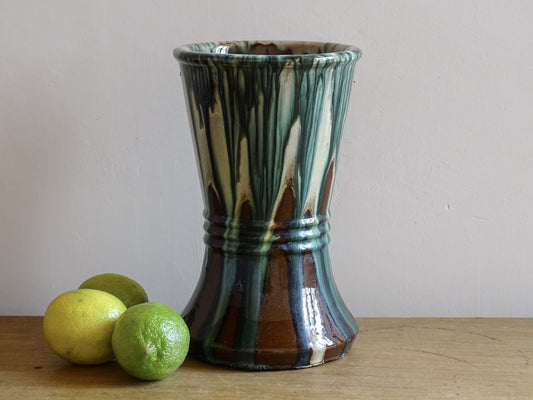 French antique terracotta vase with blue drip glaze on rustic wooden surface