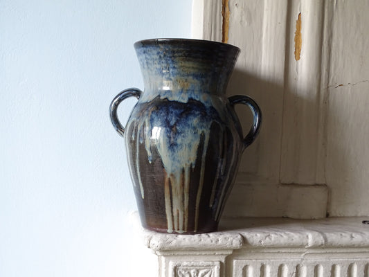 Large French vintage ceramic vase with two handles and blue drip glaze, pictured on a fireplace mantelpiece