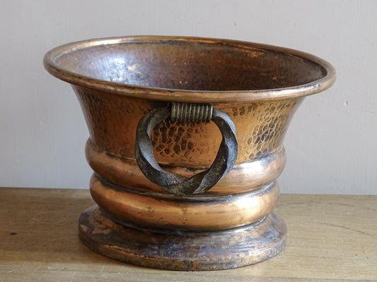 French antique hammered copper planter with iron handles. The copper has developed a rich, lived-in patina, with darker areas around the handles and base.