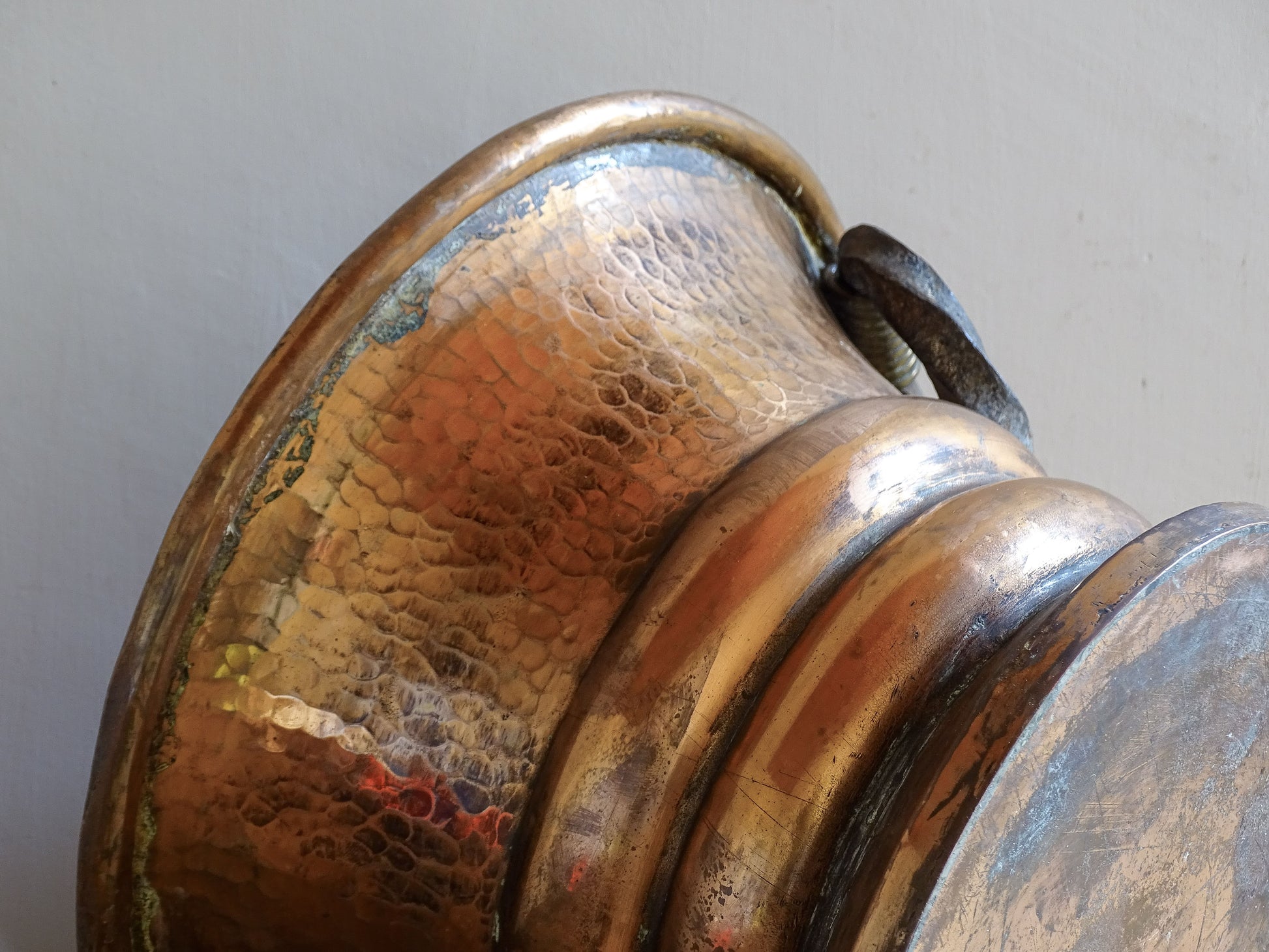 French antique hammered copper planter with iron handles. The copper has developed a rich, lived-in patina, with darker areas around the handles and base.