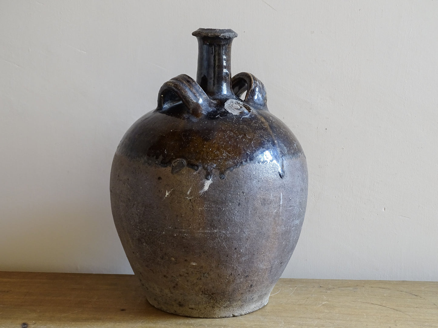 Antique French cruche with twin handles and deep brown glaze finish