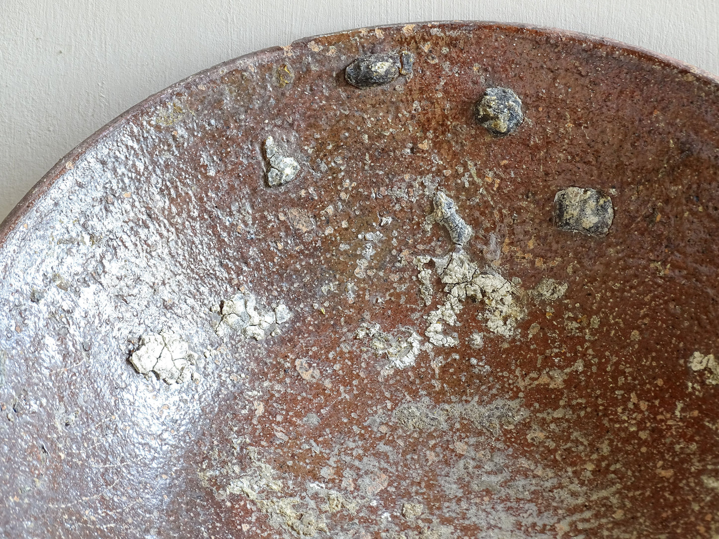 Early French pottery bowl styled with citrus on wooden surface