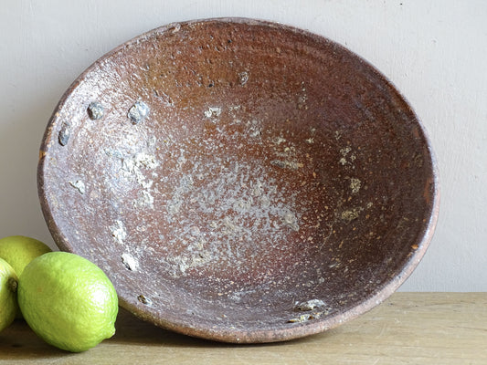 Antique French pottery bowl with deep brown glazed interior and wear