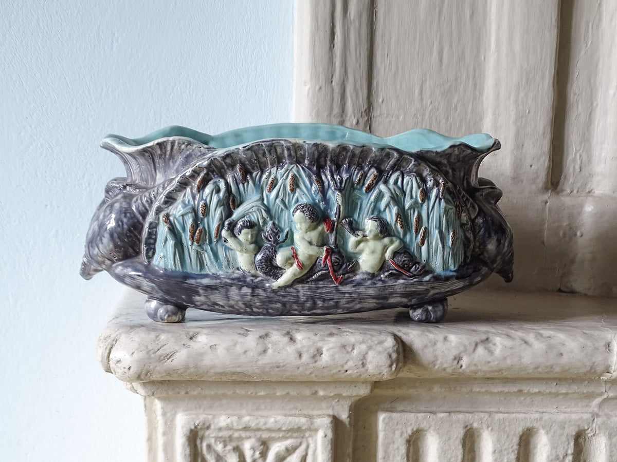 French antique ceramic barbotine cache pot with cherubs and shells, pictured on a country house fireplace