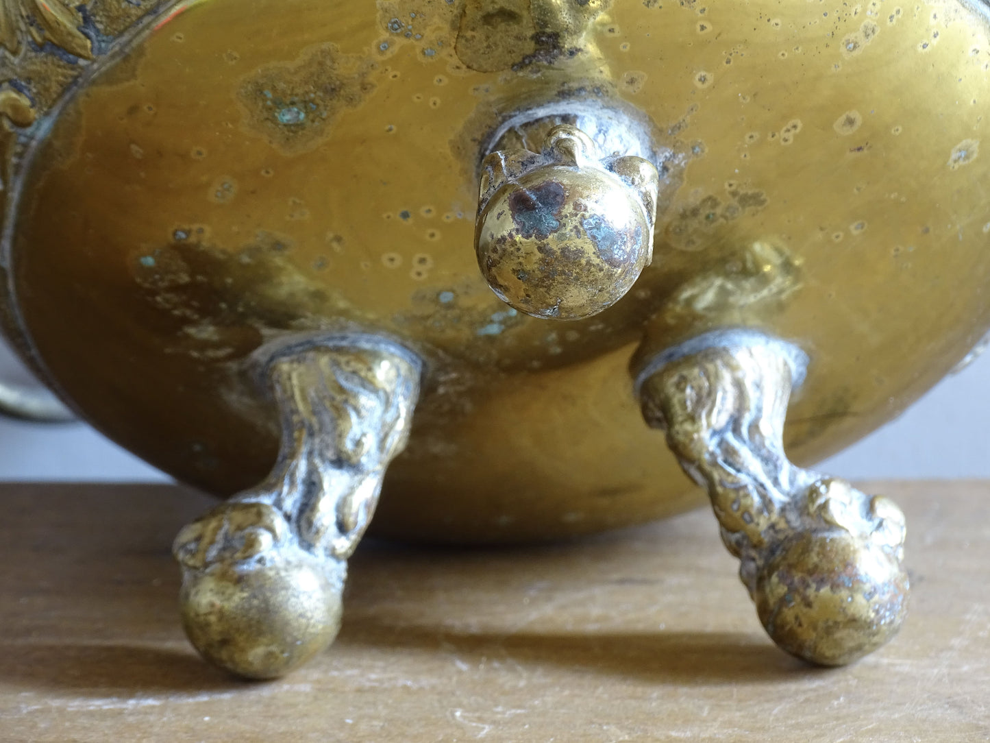 Highly ornate French antique brass jardinière with ball and claw feet. Dating to the late nineteenth century. It is such a decorative piece with richly detailed floral and scrolling relief.