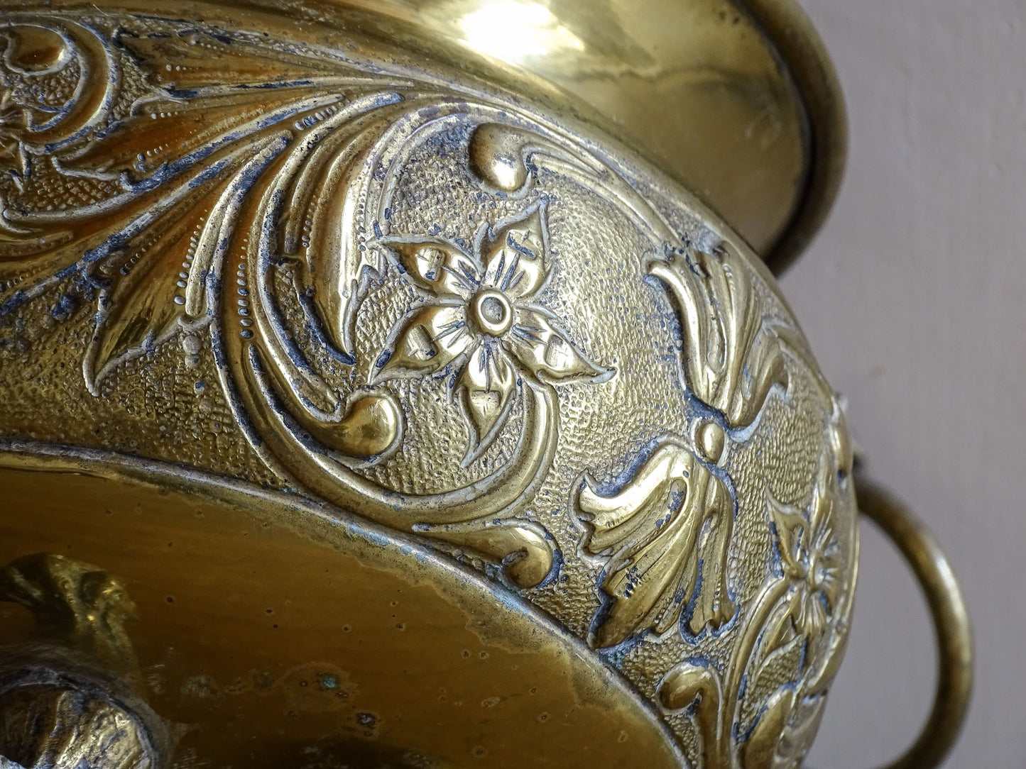 Highly ornate French antique brass jardinière with ball and claw feet. Dating to the late nineteenth century. It is such a decorative piece with richly detailed floral and scrolling relief.