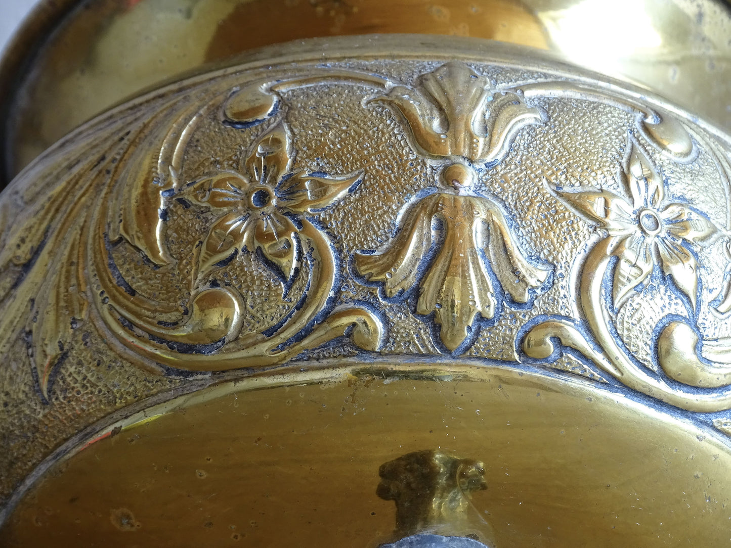 Highly ornate French antique brass jardinière with ball and claw feet. Dating to the late nineteenth century. It is such a decorative piece with richly detailed floral and scrolling relief.