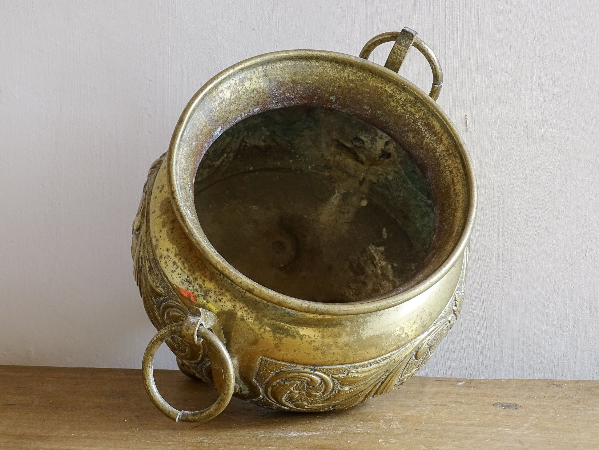 Highly ornate French antique brass jardinière with ball and claw feet. Dating to the late nineteenth century. It is such a decorative piece with richly detailed floral and scrolling relief.
